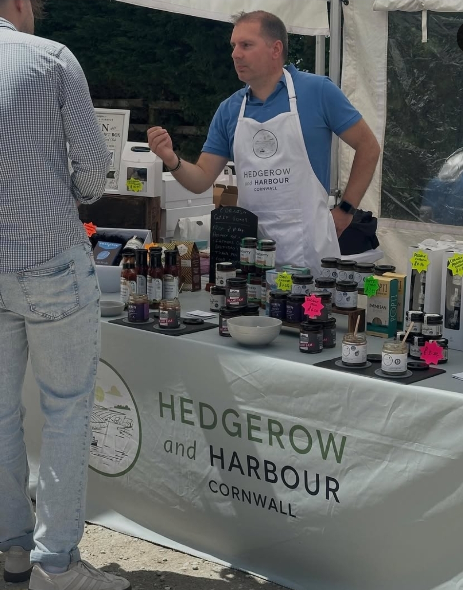 Hedgerow and Harbour Cornwall stall with jars of preserves and sauces