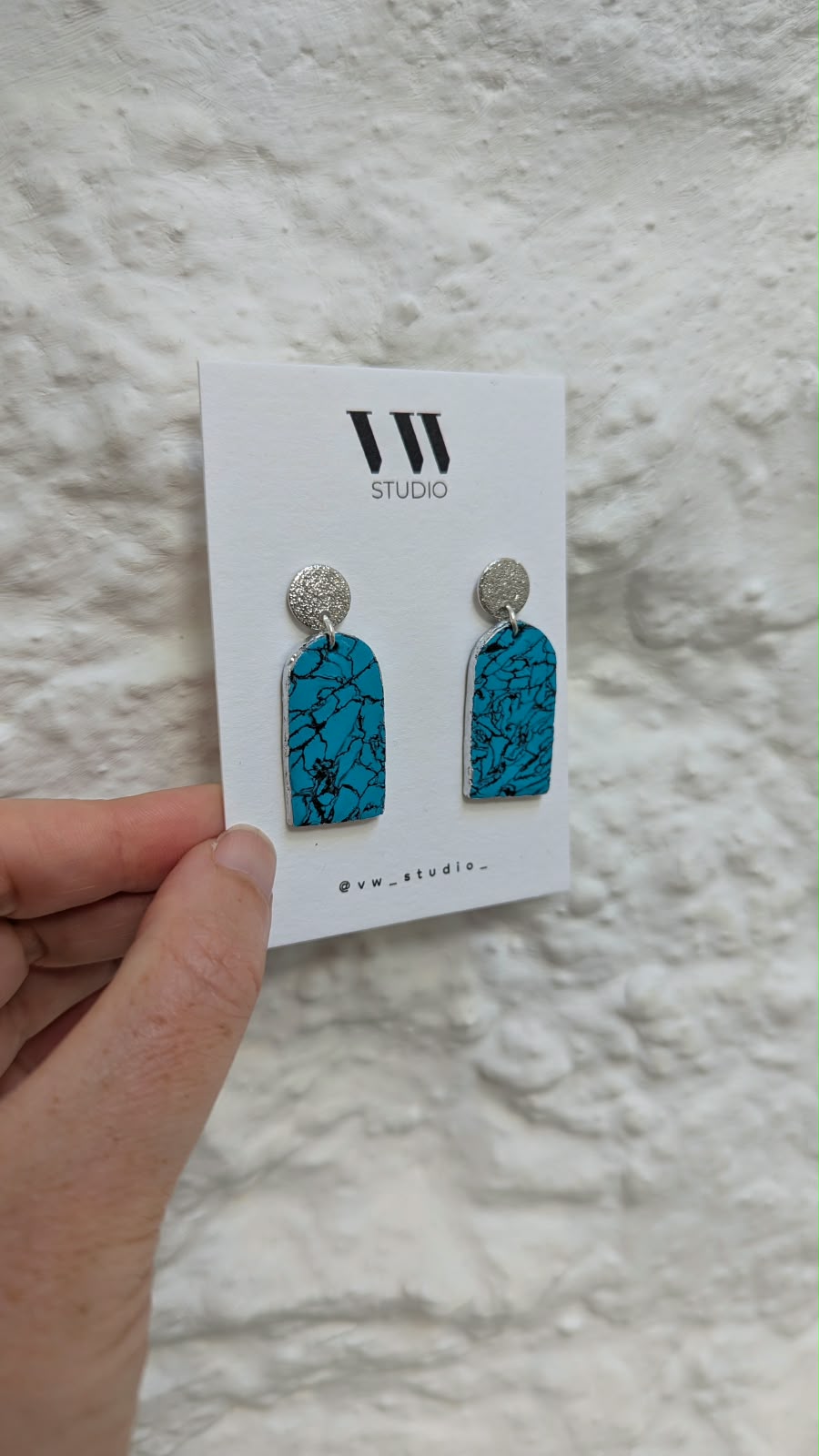 Blue marbled VW Studio drop earrings on their display card